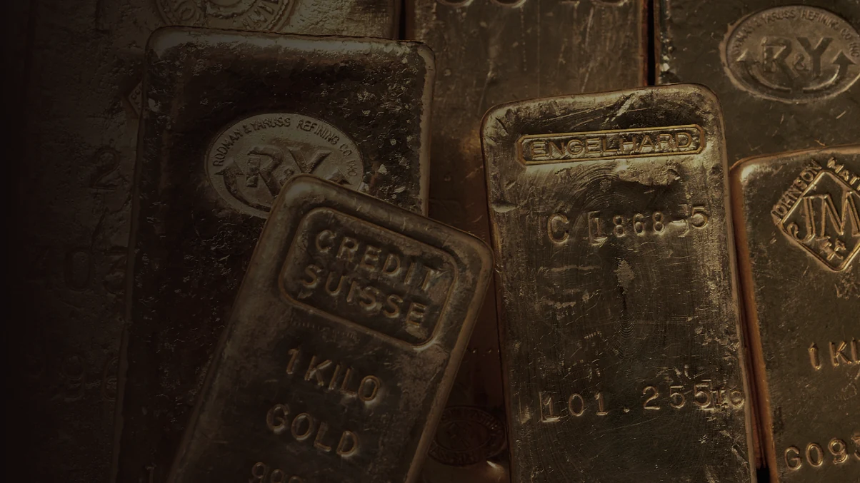 Cast one kilogramme gold bars stacked in low light