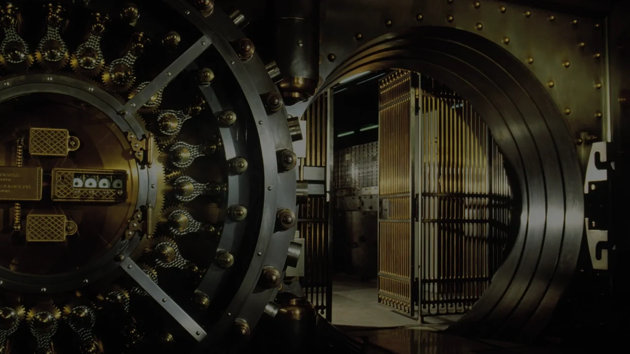 An open vault door with the internal locking mechanism visible